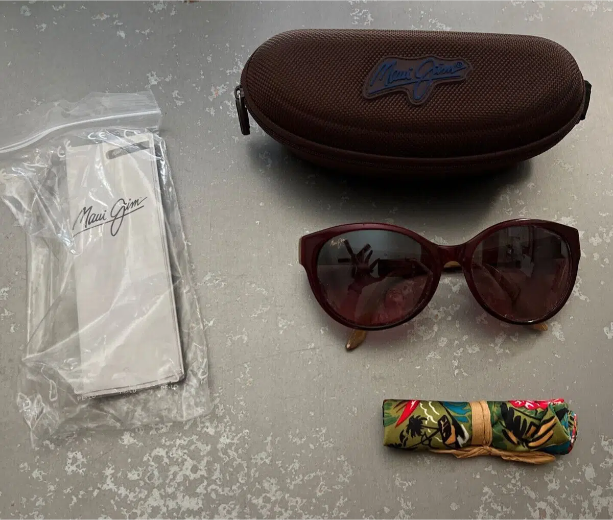 Maui Jim sunglasses with a case and instruction