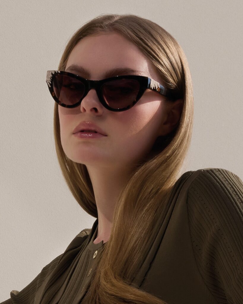 Woman in Marciano cat-eye sunglasses