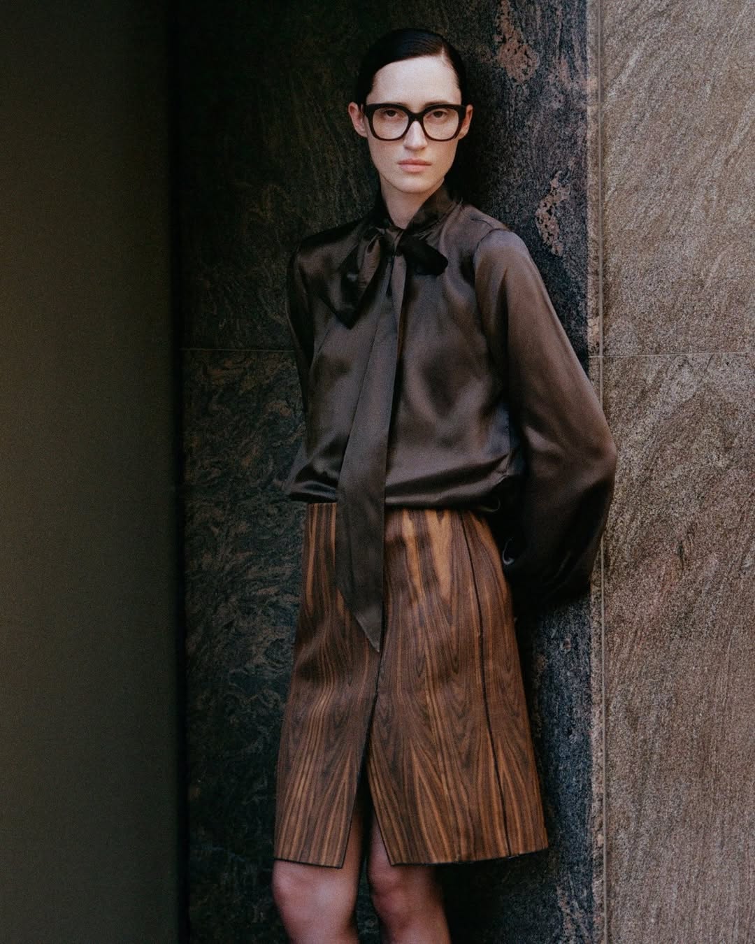 Thin woman in oversized acetate glasses